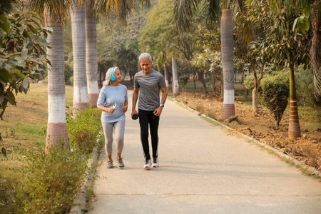 Senior couple jogging in park at morning. Healthy lifestyle and fitness concept.の写真素材