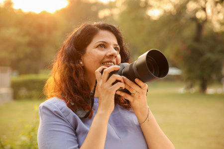 Portrait of a middle-aged woman with a camera in the park