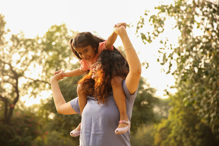 Mother and daughter having fun together in the park. Happy family concept.の写真素材