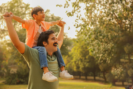 Father and son having fun in the park. Concept of friendly family.の写真素材