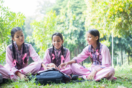 Group of asian girls with breast cancer awareness ribbon in the parkの写真素材