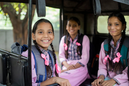 Portrait of smiling schoolgirl riding tuk tuk in school bus