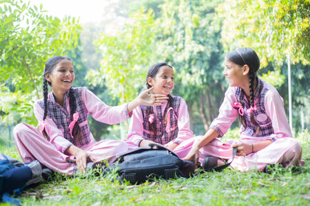 Portrait of asian thai student girls sitting on the grass.の写真素材