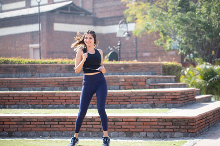 Beautiful young woman jogging. Fitness and healthy lifestyle concept.