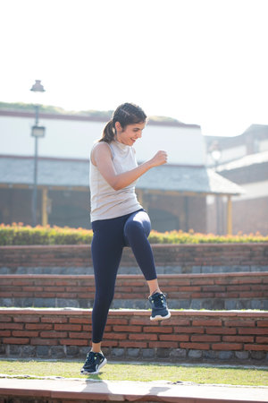 Young woman jogging in the city. Female runner exercising outdoors.