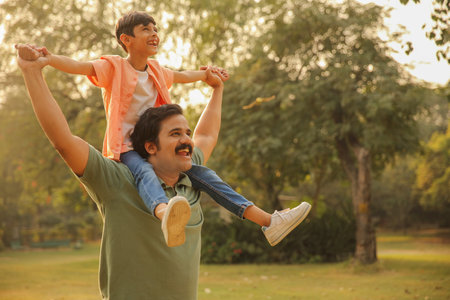 Father and son playing in the park at the day time. Concept of friendly family.の写真素材