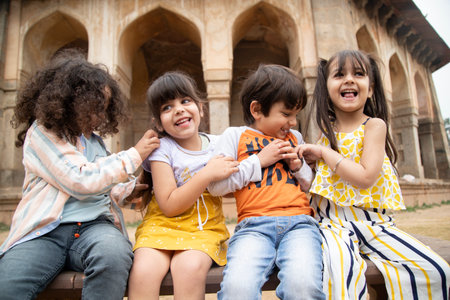 Group of kids having fun in the courtyard of Taj Mahal, Agra, Indiaの写真素材