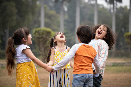 Group of happy kids having fun together in the park on summer dayの写真素材