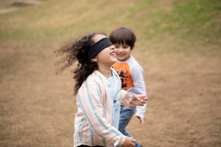 Happy children playing in the park on a sunny day. Selective focus.の写真素材