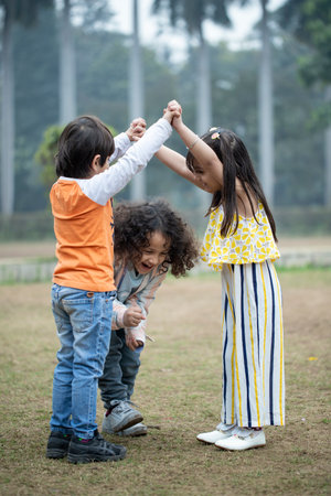 Group of kids playing together in the park, friendship and fun conceptの写真素材