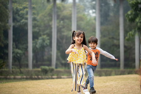 Happy asian family playing together in the park. Little boy and girl playing together.の写真素材