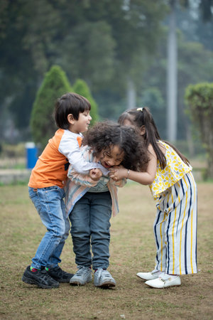 Happy kids playing together in the park. Friendship and childhood concept.の写真素材