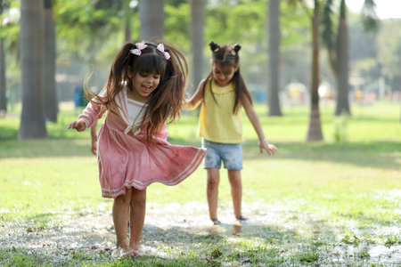 Cute little girls playing together in the park. Happy childhood concept.の写真素材