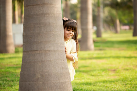 Cute little girl in a park on a sunny day. Selective focus.の写真素材