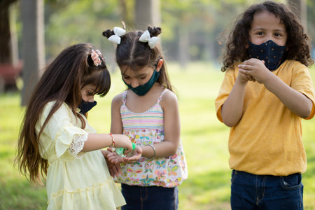 Group of children wearing face masks in the park. Coronavirus concept.の写真素材