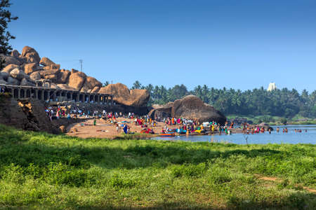 Hampi, Karnataka, India - January 10, 2020 : People bathing and getting ready on the banks of river...