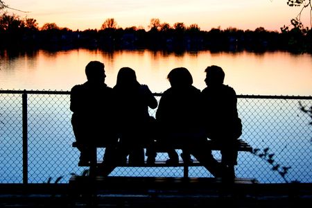 sunset at the lake with friendsの写真素材