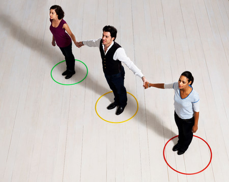 Man and women holding hands in circlesの写真素材