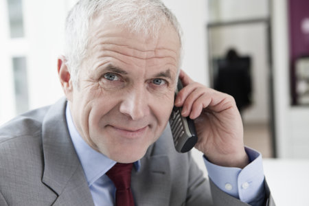 Phoning man looking at cameraの写真素材