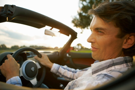 Man driving an electric sports carの写真素材