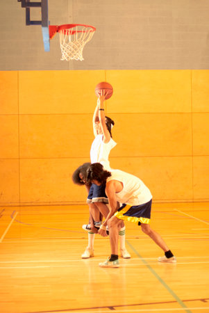 Lifting player up to basketの写真素材