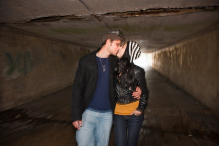 Couple kissing in tunnelの写真素材