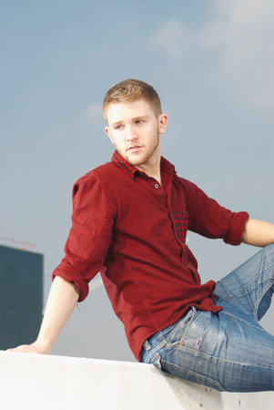 Man sitting on wallの写真素材