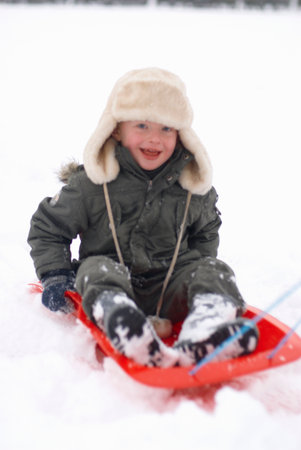 Boy on sledgeの写真素材