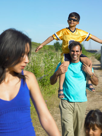 Family walking on rural roadの写真素材