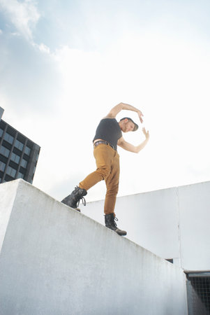 Man dancing on urban rooftopの写真素材