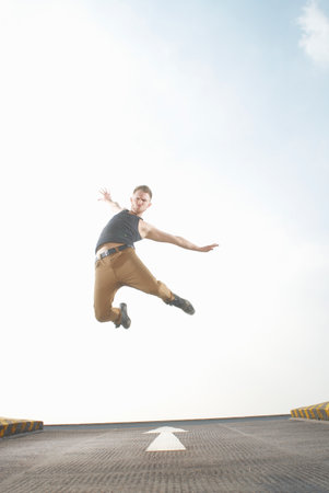 Man jumping in roadの写真素材