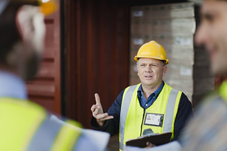 Workers talking in shipping yard