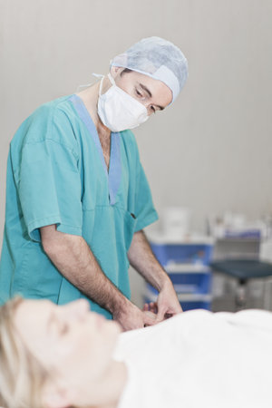 Doctor preparing patient for surgeryの写真素材