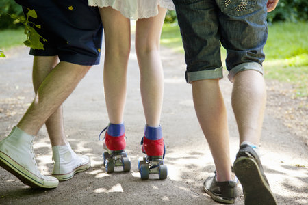 Teenage boys with roller skating girlの写真素材