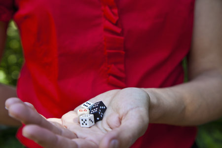 Woman holding dice in handの写真素材