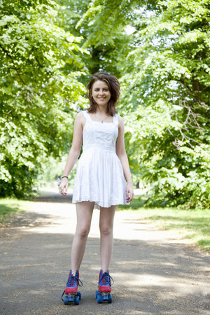Teenage girl in roller skates in parkの写真素材