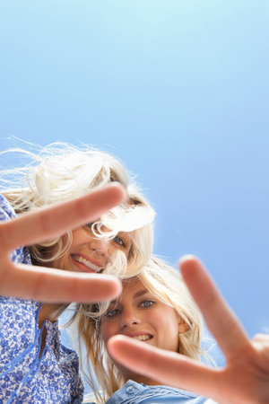 Sisters making peace sign together
