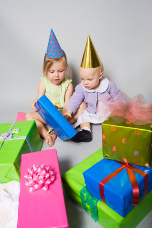Little girls with birthday presentsの写真素材