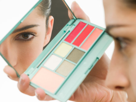 Young woman with makeup mirrorの写真素材