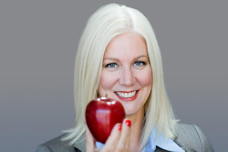 Woman holding an appleの写真素材