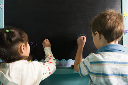 Children writing on a blackboardの写真素材