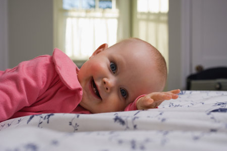 Baby lying on bed