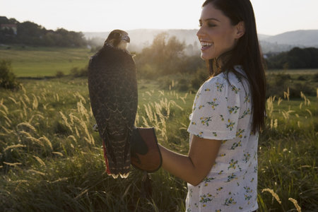 Woman holding bird.の写真素材
