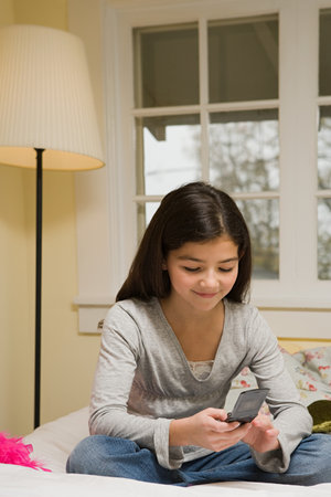 A girl texting on her cell phoneの写真素材