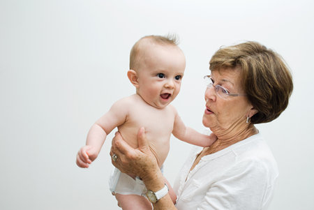 Grandmother holding baby grandsonの写真素材