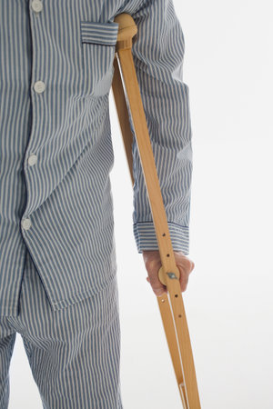 Man holding wooden crutch