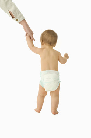 Adult helping baby to walk