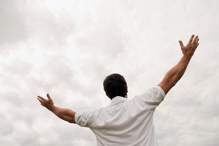 Man worshipping with open armsの写真素材