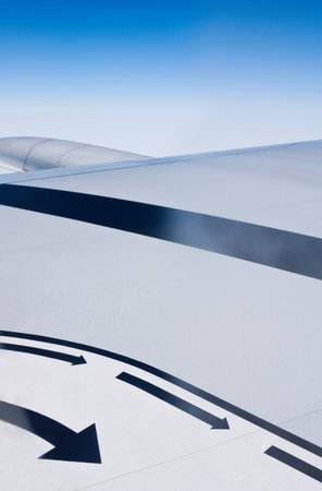 Airplane wing seen with arrowsの写真素材