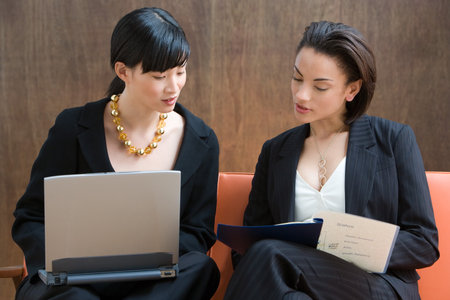 Two young women working with laptopの写真素材